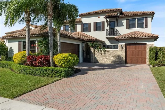 a front view of a house with a garden and plants