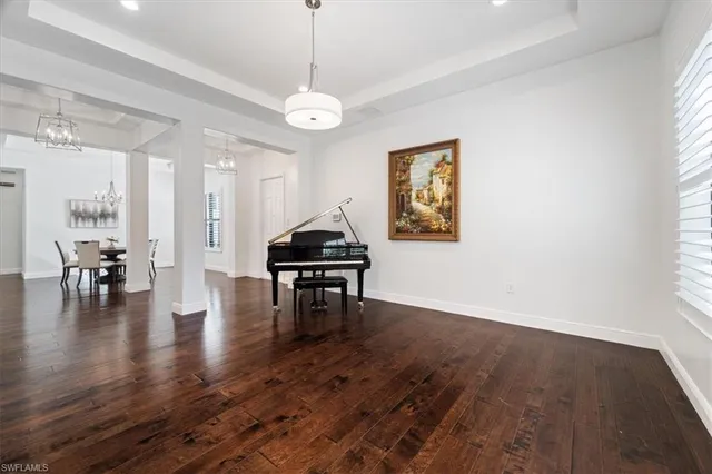 a view of a livingroom with furniture wooden floor a chandelier