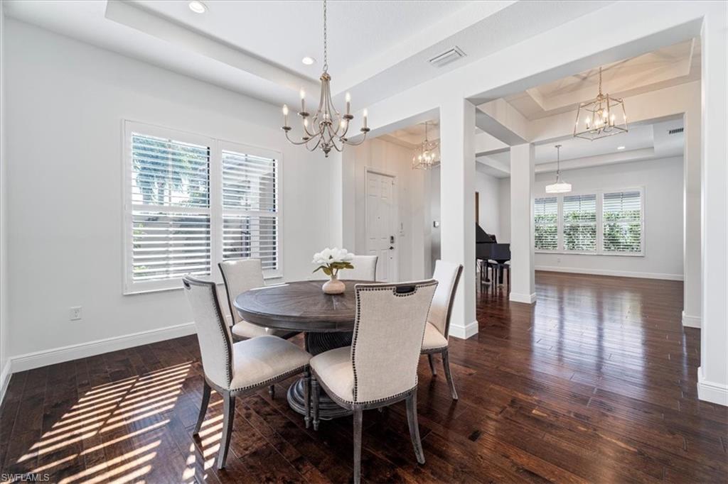 5135 Genoa Street Ave Maria, FL 34142 - Photo 12 of 35 a view of a dining room with furniture wooden floor and chandelier