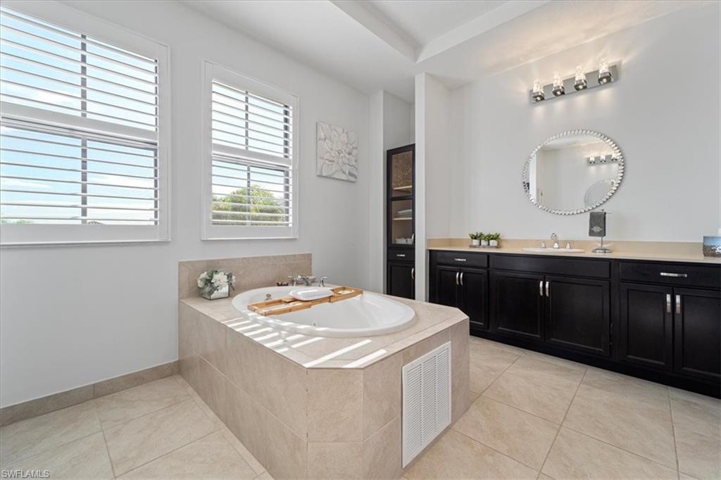 5135 Genoa Street Ave Maria, FL 34142 - Photo 19 of 35 a kitchen with a sink and a stove