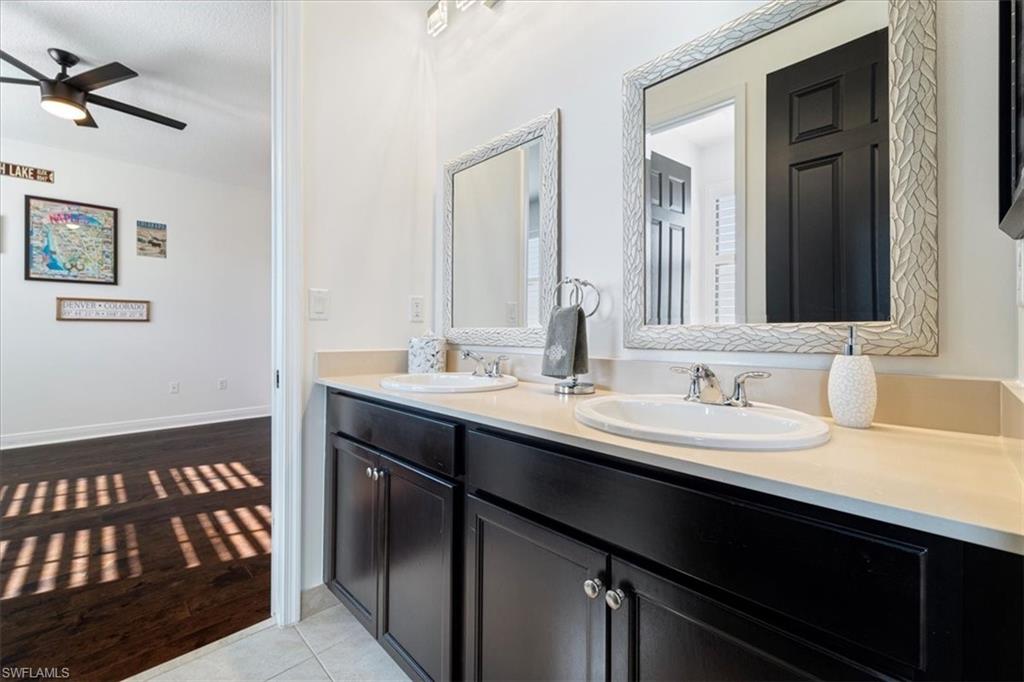 5135 Genoa Street Ave Maria, FL 34142 - Photo 24 of 35 a bathroom with a sink and a mirror