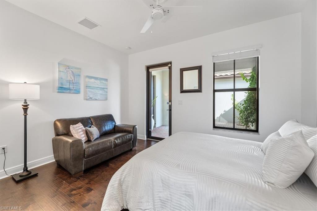 5135 Genoa Street Ave Maria, FL 34142 - Photo 26 of 35 a bedroom with a bed couch and window