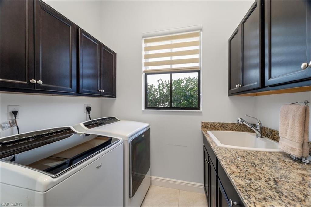 5135 Genoa Street Ave Maria, FL 34142 - Photo 27 of 35 a kitchen that has a sink and a stove