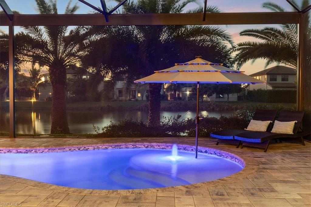 5135 Genoa Street Ave Maria, FL 34142 - Photo 3 of 35 a view of a patio with a table under an umbrella
