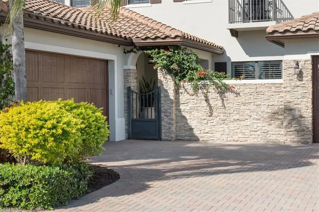 a view of a house with potted plants