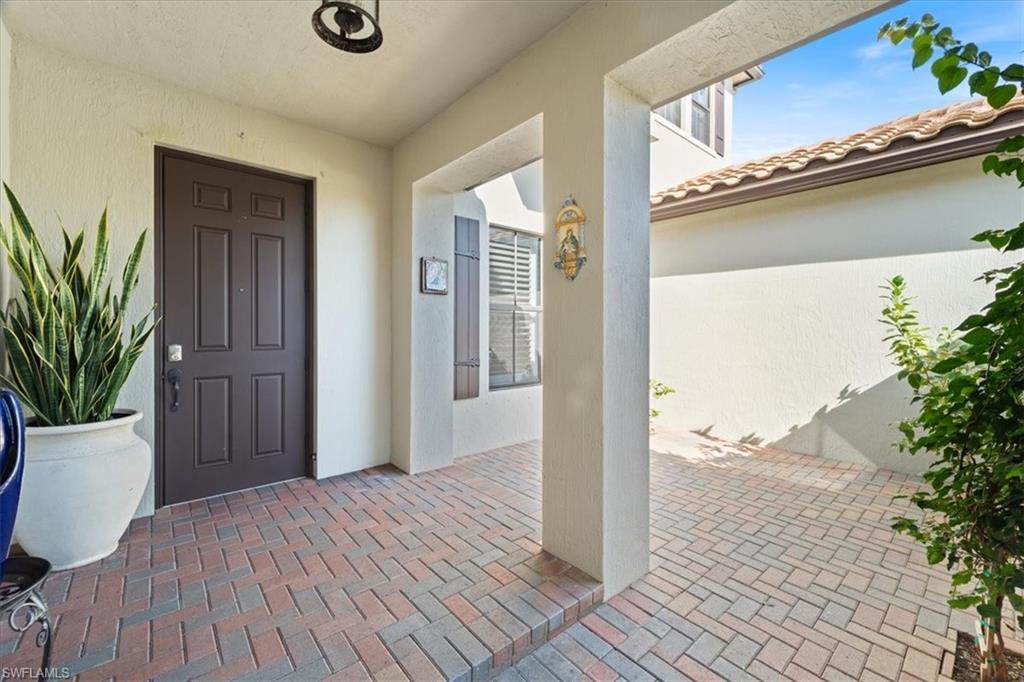 5135 Genoa Street Ave Maria, FL 34142 - Photo 8 of 35 a view of a room that has a door and wooden floor
