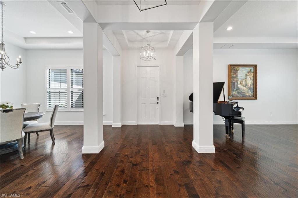 5135 Genoa Street Ave Maria, FL 34142 - Photo 10 of 35 a view of a livingroom with furniture and wooden floor