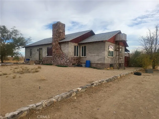 a front view of a house with a yard covered in snow