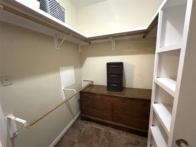 a bedroom with bed and a chandelier