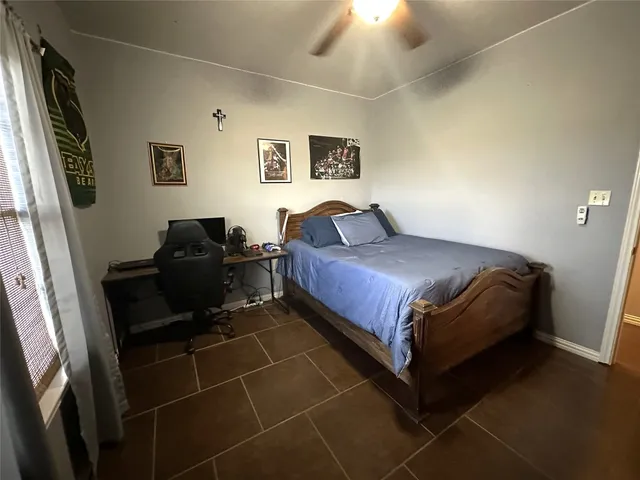 a bathroom with a granite countertop sink a toilet and mirror