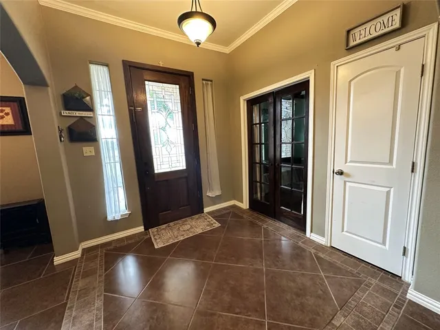 a view of an entryway with wooden floor and door