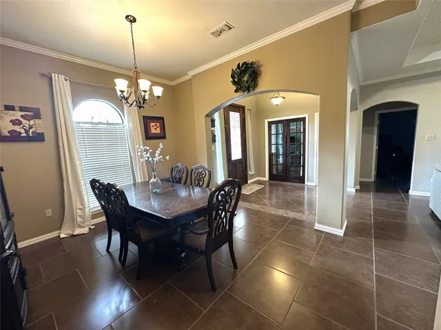 a view of a dining room with furniture and chandelier