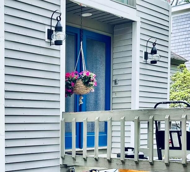 87 Tracey Road Cotuit, MA 02635 - Photo 14 of 33 a front view of a building with balcony