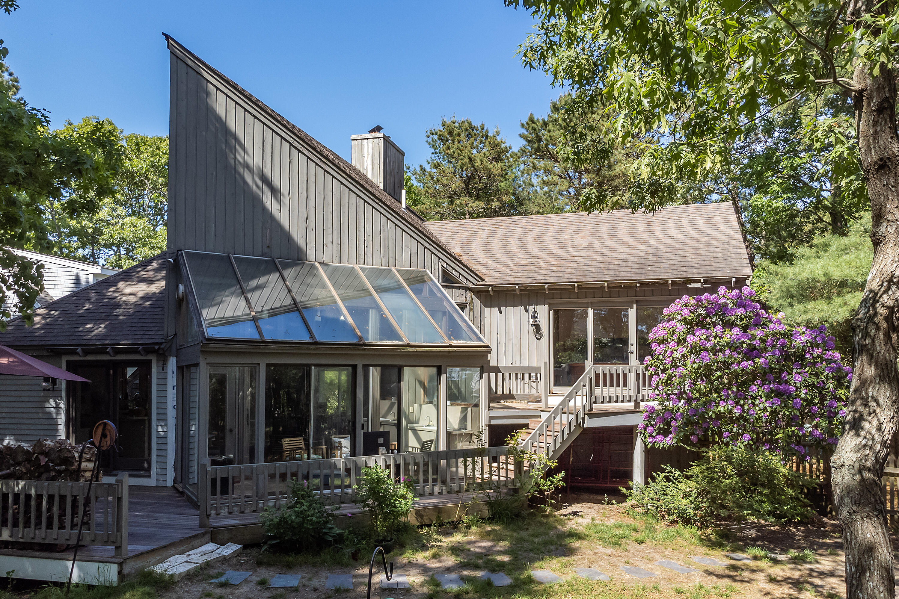 87 Tracey Road Cotuit, MA 02635 - Photo 9 of 33 a front view of a house with garden and patio