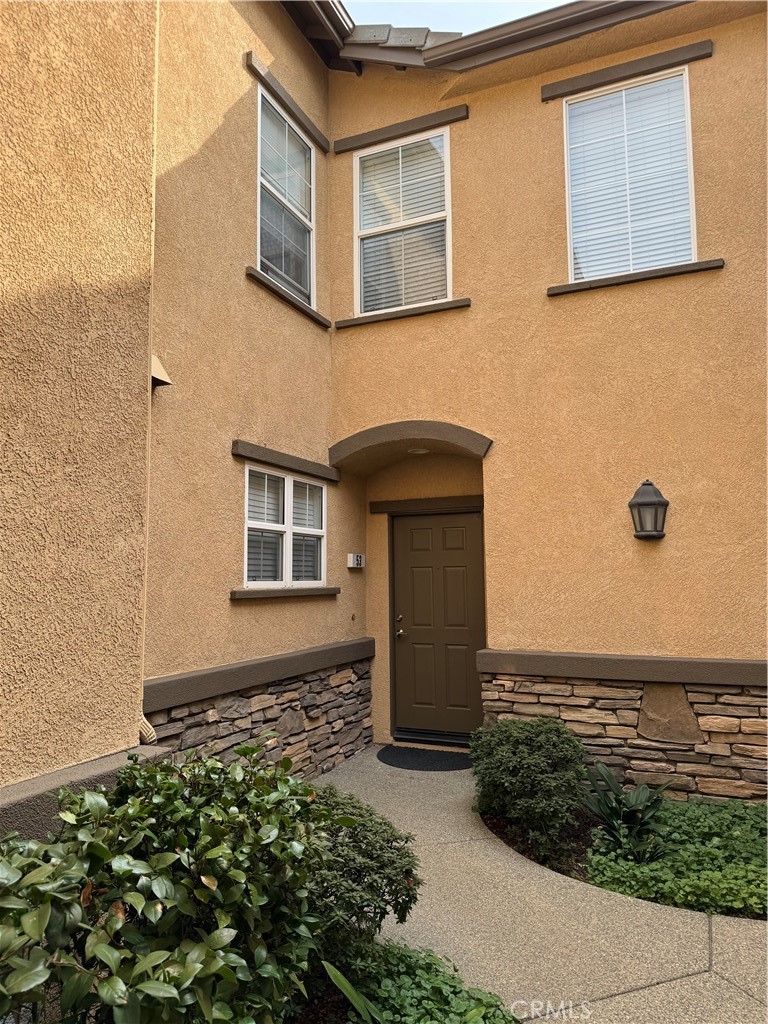 7353 Ellena West, Unit 53 Rancho Cucamonga, CA 91730 - Photo 1 of 1 a front view of a house with plants