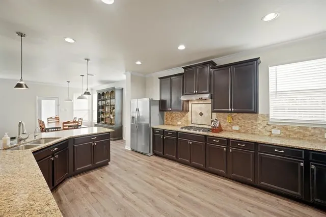 a large kitchen with stainless steel appliances lots of counter top space