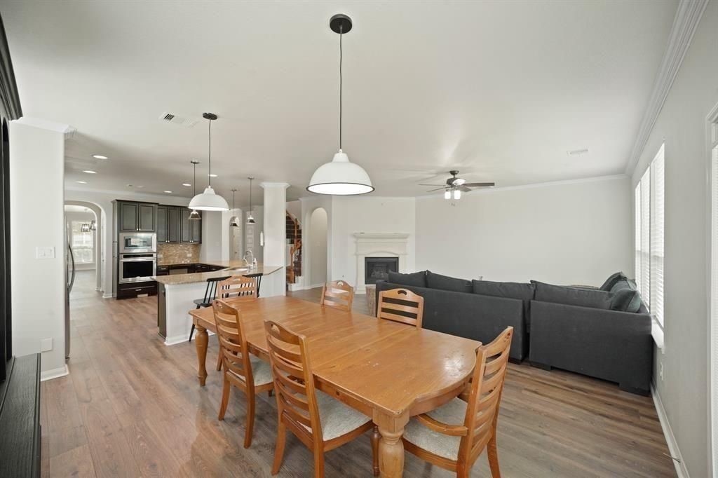 20358 Mathis Landing Drive Cypress, TX 77433 - Photo 13 of 32 a view of a dining room and livingroom with furniture wooden floor a chandelier