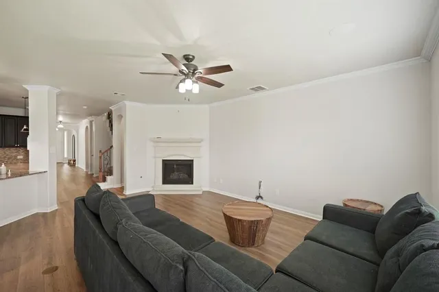 a living room with furniture a fireplace and a chandelier