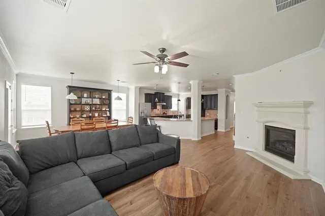 a living room with furniture fireplace and window