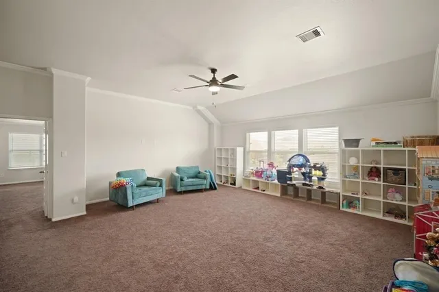 a view of a livingroom with furniture and a ceiling fan
