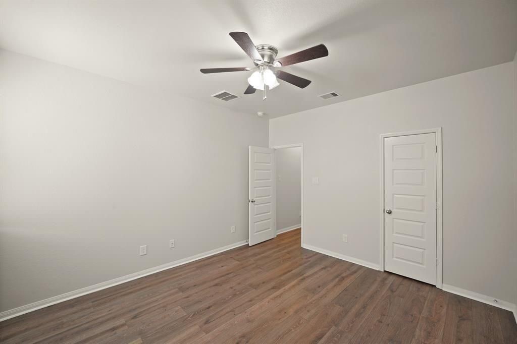 20358 Mathis Landing Drive Cypress, TX 77433 - Photo 24 of 32 a view of an empty room with wooden floor