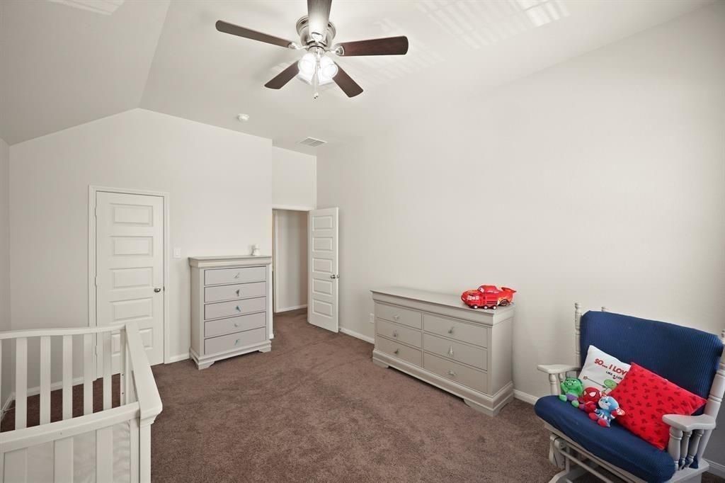 20358 Mathis Landing Drive Cypress, TX 77433 - Photo 25 of 32 a bedroom with furniture and a chandelier fan