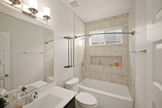 a bathroom with a bathtub a toilet and a shower