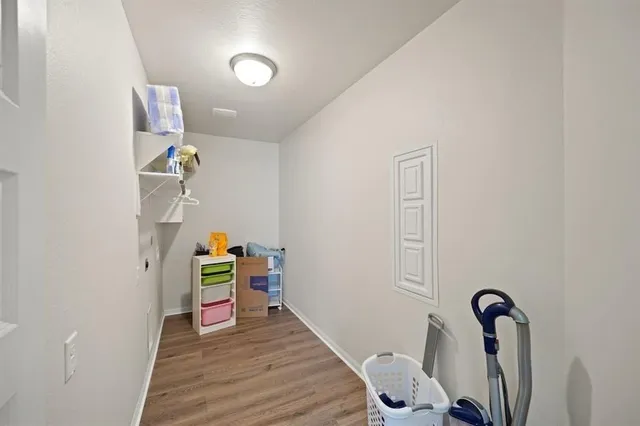 a view of a room with wooden floor and closet