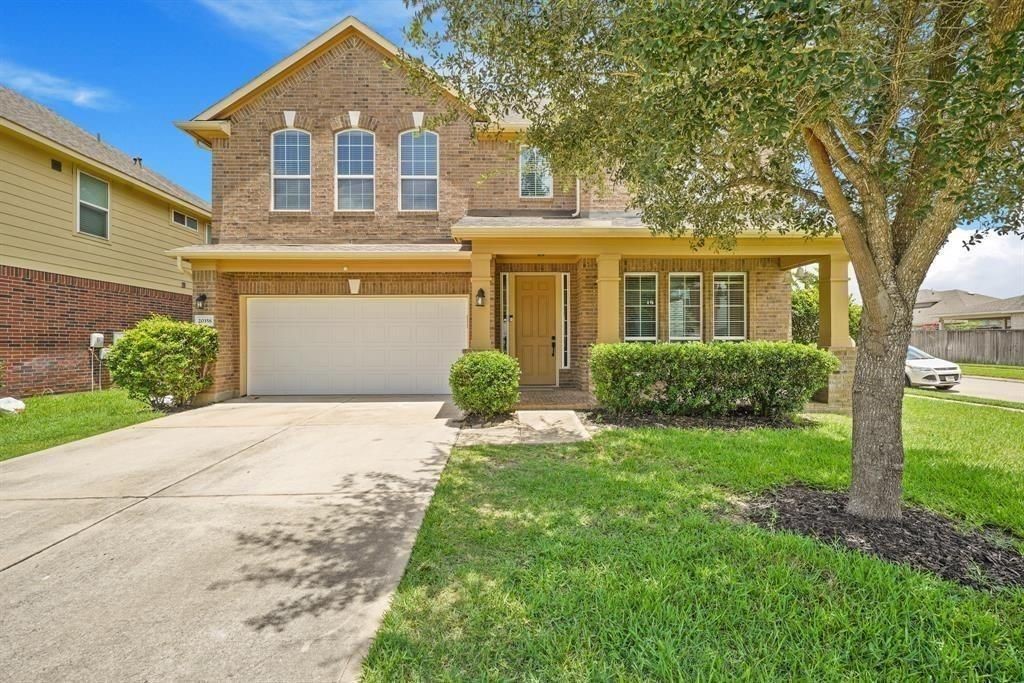 20358 Mathis Landing Drive Cypress, TX 77433 - Photo 7 of 32 a front view of a house with a yard and trees