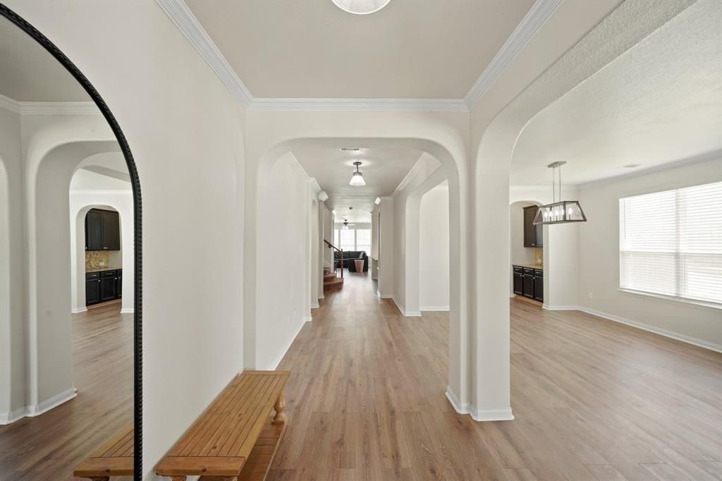 20358 Mathis Landing Drive Cypress, TX 77433 - Photo 8 of 32 a view of a hallway view with wooden floor and staircase