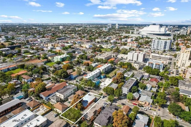 an aerial view of residential houses with city view