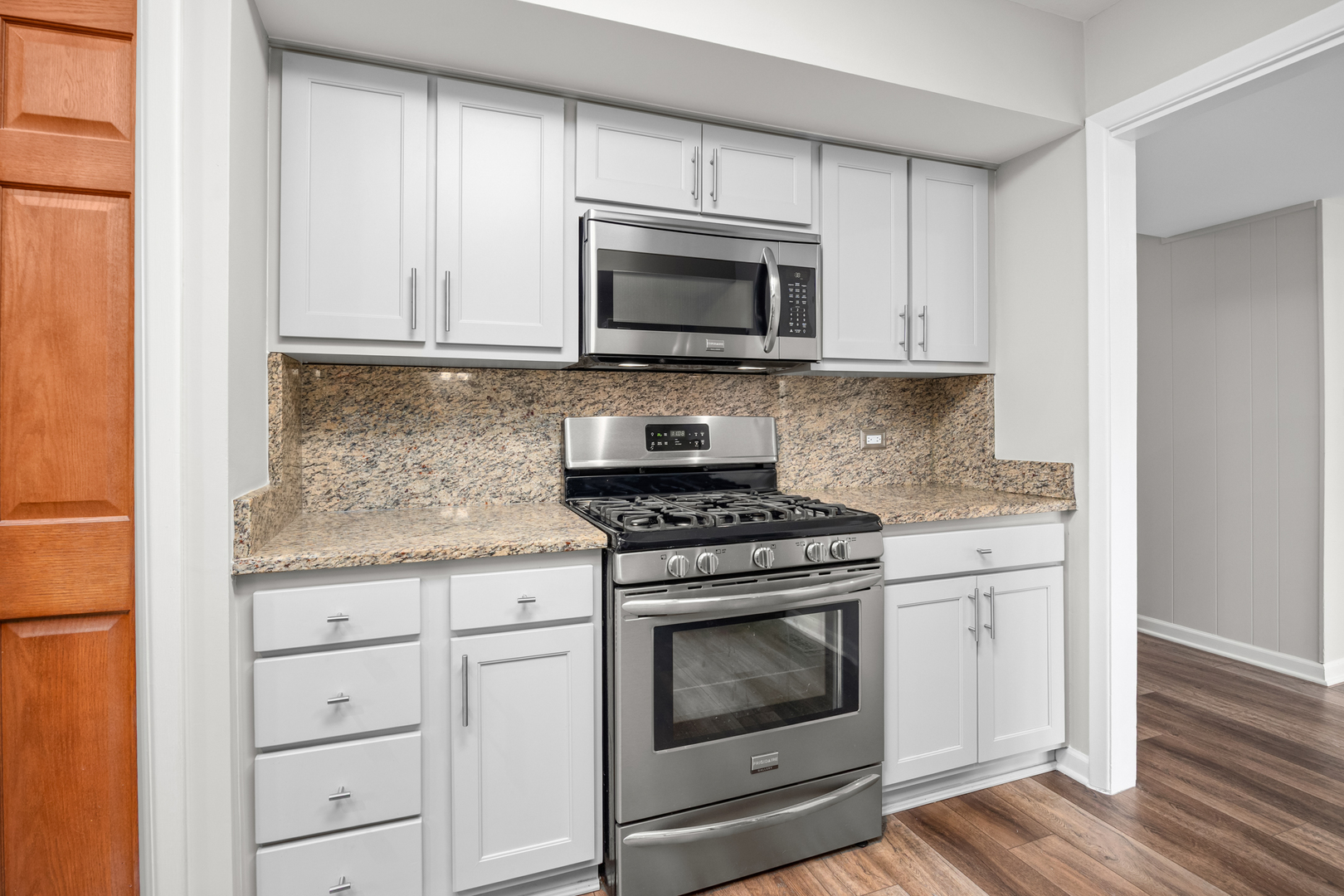 1505 Chartwell Road Hoffman Estates, IL 60169 - Photo 11 of 38 a kitchen with granite countertop white cabinets and stainless steel appliances