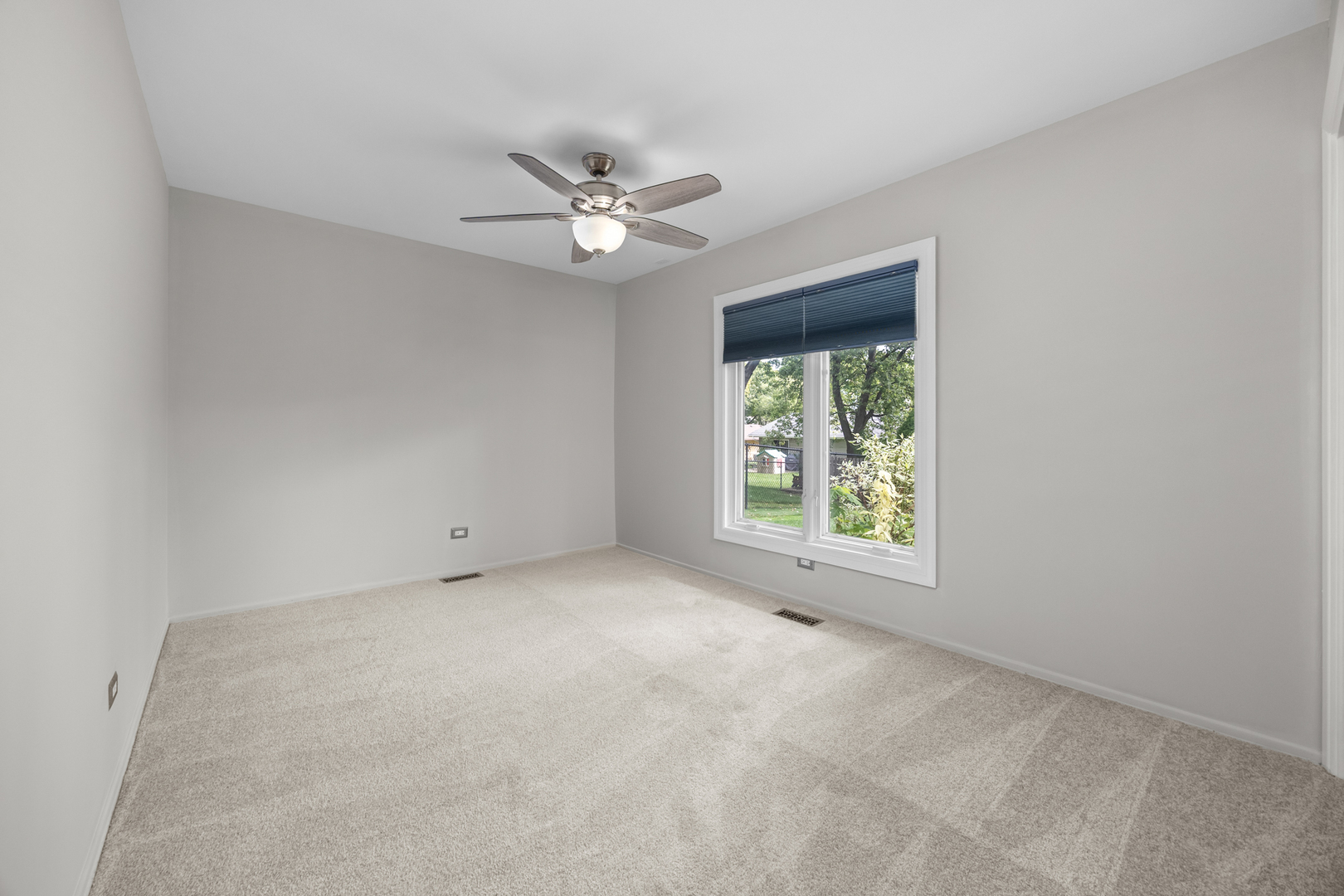 1505 Chartwell Road Hoffman Estates, IL 60169 - Photo 22 of 38 an empty room with a window and a fan
