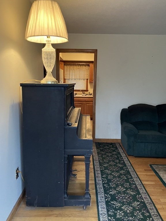 31 Alice Street Springfield, MA 01109 - Photo 2 of 10 a living room with a table and a chandelier
