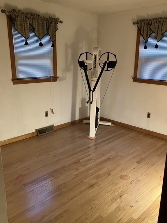 31 Alice Street Springfield, MA 01109 - Photo 6 of 10 a view of a room with wooden floor and white walls
