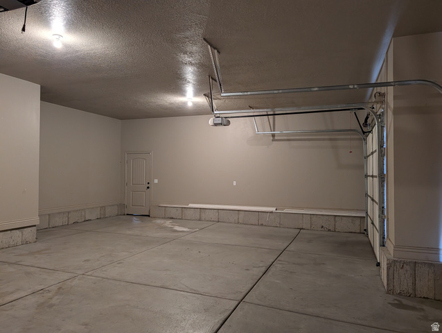 171 South Mustang Road East Grantsville, UT 84029 - Photo 37 of 41 Spacious two-car garage featuring a concrete floor, painted walls, and an interior access door