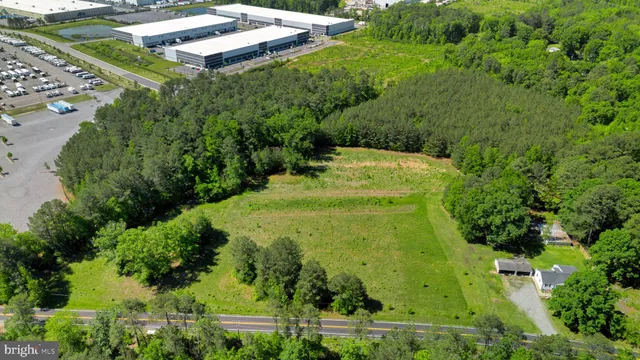 an aerial view of a house with a yard patio and swimming pool