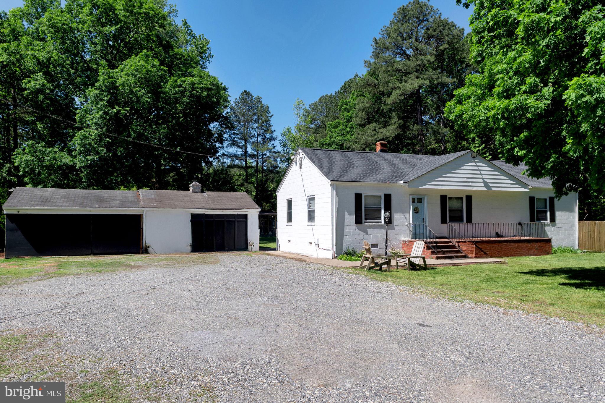 10439 Ashcake Road Ashland, VA 23005 - Photo 4 of 27 a front view of house with yard and garage
