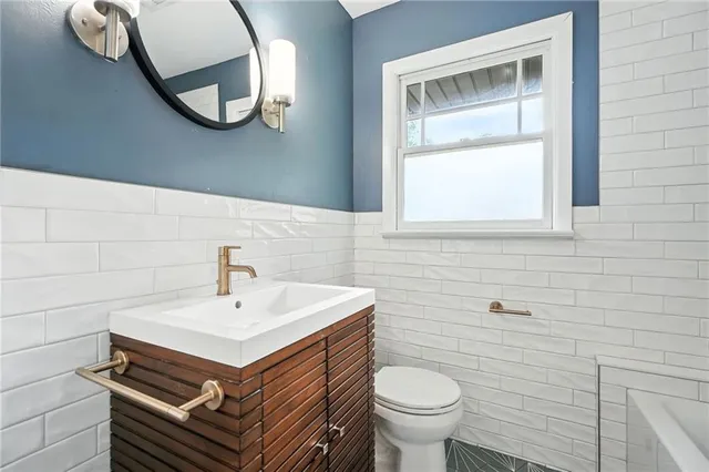 a bathroom with a sink a mirror and a toilet