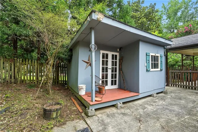a backyard of a house with table and chairs