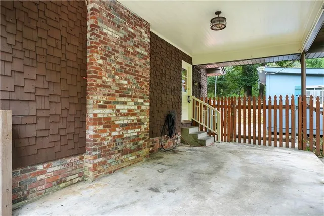 a view of a porch with furniture and garden