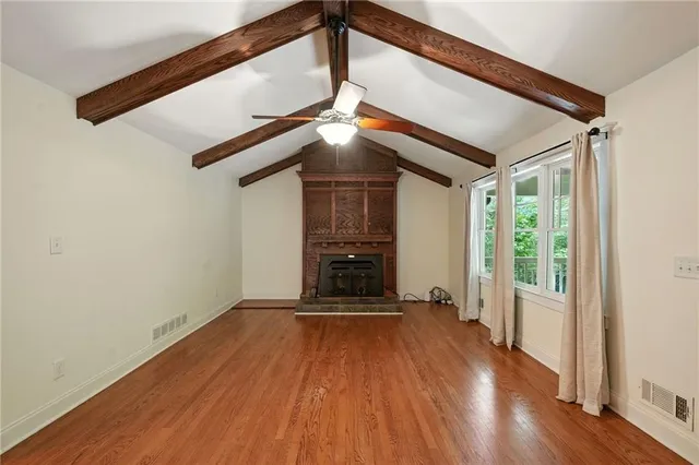 a kitchen with granite countertop a stove a sink and dishwasher wooden cabinets with granite countertops