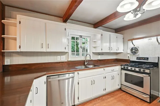 a kitchen with a refrigerator and countertop sink