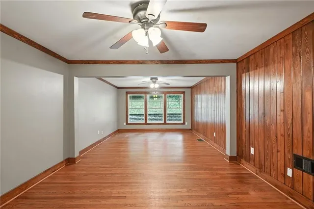 a view of an empty room with a ceiling fan