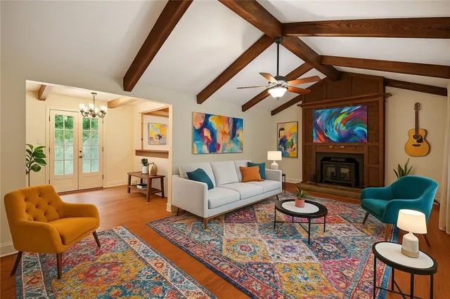 a living room with furniture a rug a fireplace and a large window