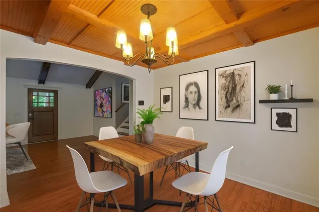 a view of a dining room with furniture wooden floor and chandelier