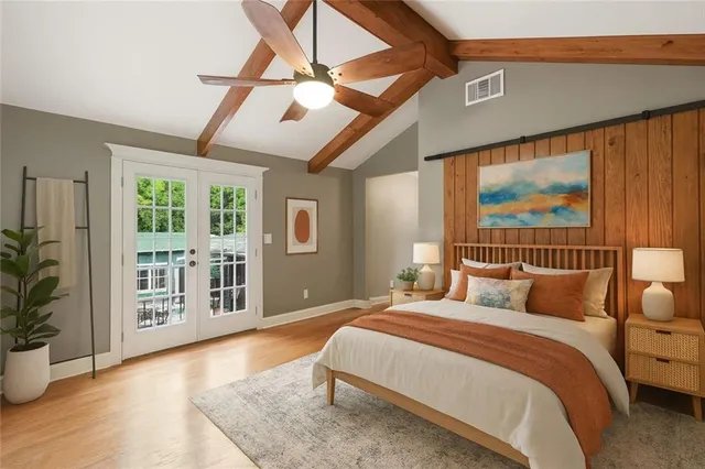 a bedroom with a large bed and a large window