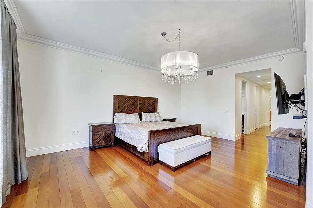 1 North Ocean Boulevard, Unit 403 Boca Raton, FL 33432 - Photo 12 of 46 a spacious bedroom with a bed and wooden floor