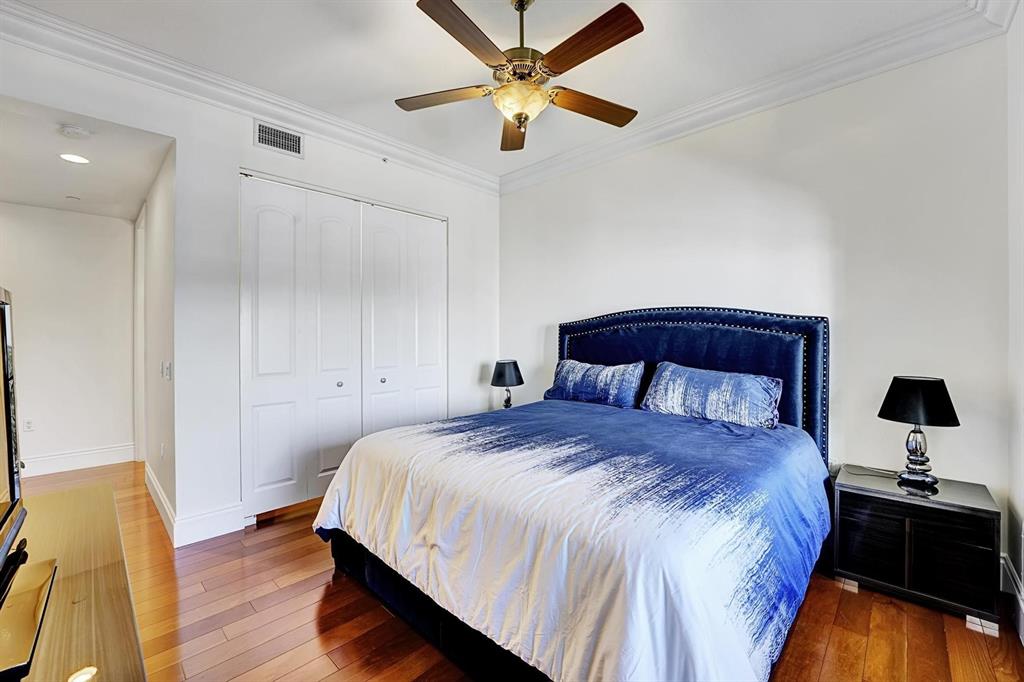 1 North Ocean Boulevard, Unit 403 Boca Raton, FL 33432 - Photo 16 of 46 a bedroom with a large bed and a chandelier