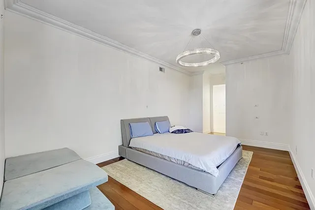 a bedroom with a bed and a night stand